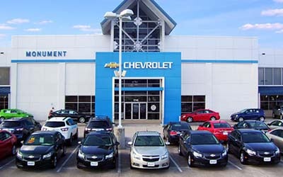 exterior of monument chevrolet with new and used cars out front